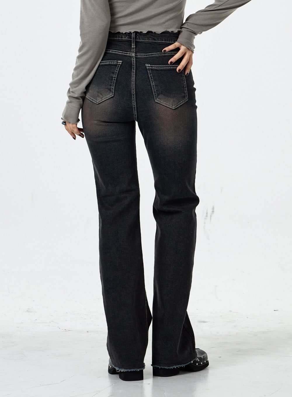 Basic Washed Bootcut Jeans CS07 in black washed denim, back close-up from waist to hem, back pockets with contrast stitching, faded wash gradient, slim bootcut leg flare visible.