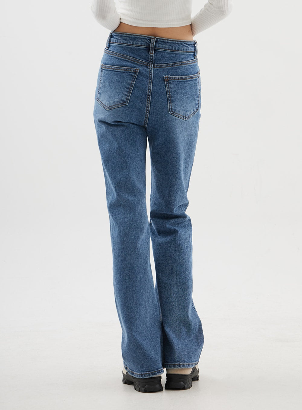 Slim Fit Bootcut Jeans CJ311 in medium blue, back view on model from waist to hem, dual back patch pockets with contrast stitching, subtle bootcut flare at ankle.