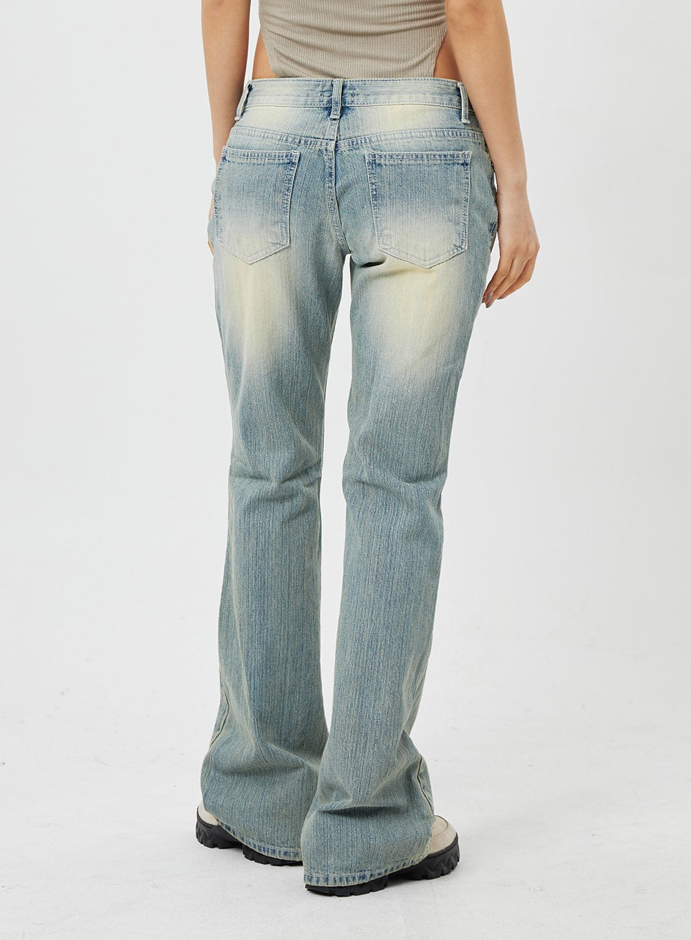 Low Rise Bootcut Jeans CF315 in light blue, back waist-to-hem close-up on model, rear patch pockets with contrast stitching, washed denim texture, bootcut hem.