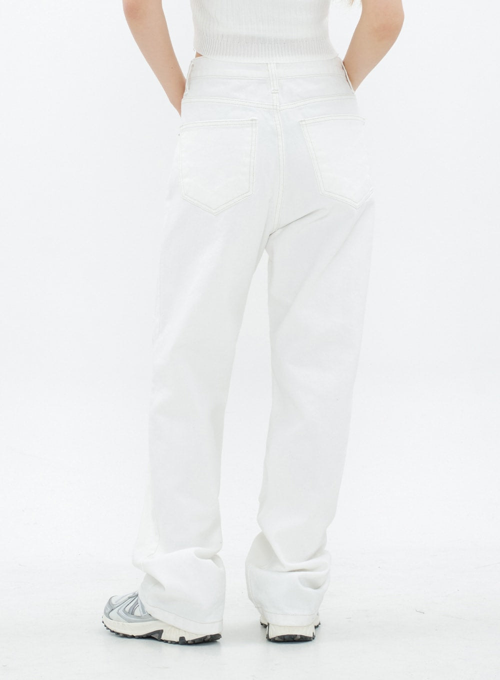 Torn Wide Leg Jeans CM18 in white, back view from waist to hem on model, showing back pockets with contrast stitching, clean solid wide leg silhouette, long length pooling at sneakers.