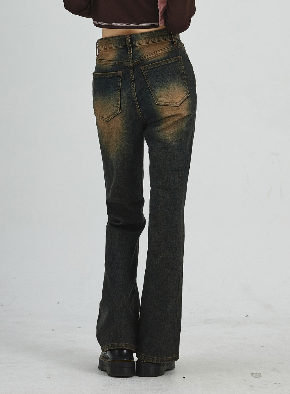 Vintage Washing Bootcut Jeans CD02 in dark washed denim, back view waist-to-hem on model, showing dual back patch pockets, amber-toned fading across seat and thigh, bootcut hem detail.