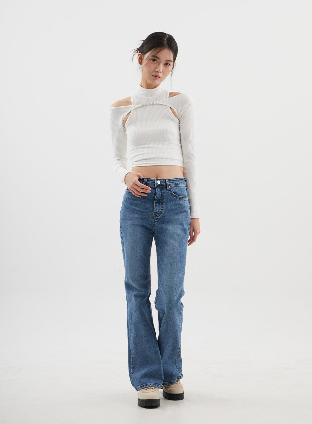 Slim Fit Bootcut Jeans CJ311 in medium blue, full-length front view on model with slight lean, mid-rise fit hugging hips, bootcut leg opening, paired with white cut-out crop top.