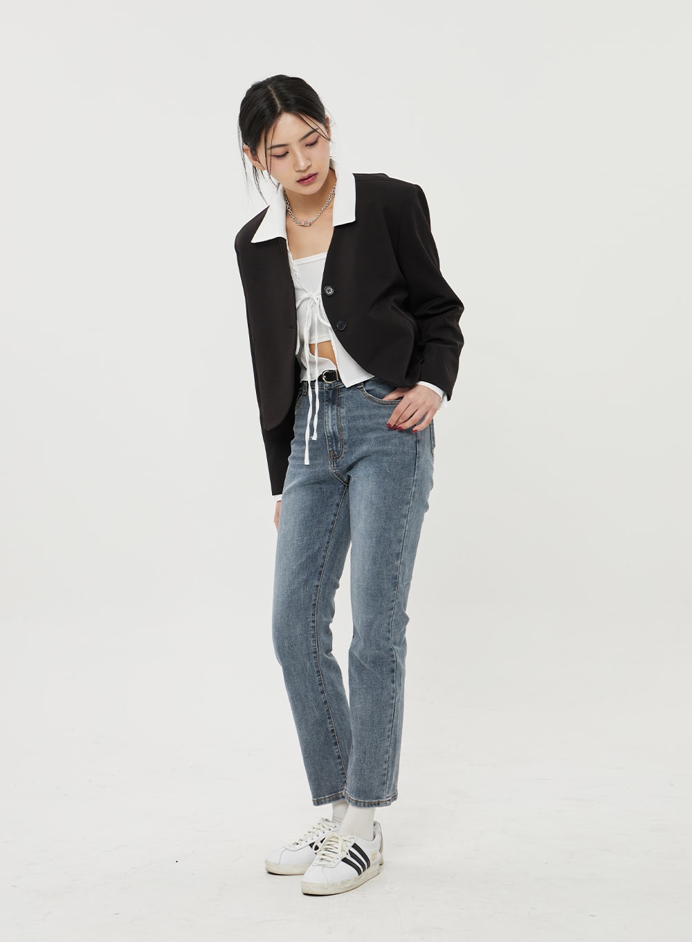 Straight Leg Ankle Jeans BF316 in mid-blue wash, front full-body on model looking down, slim fit with high-rise waist, ankle hem, layered with black blazer and white top.