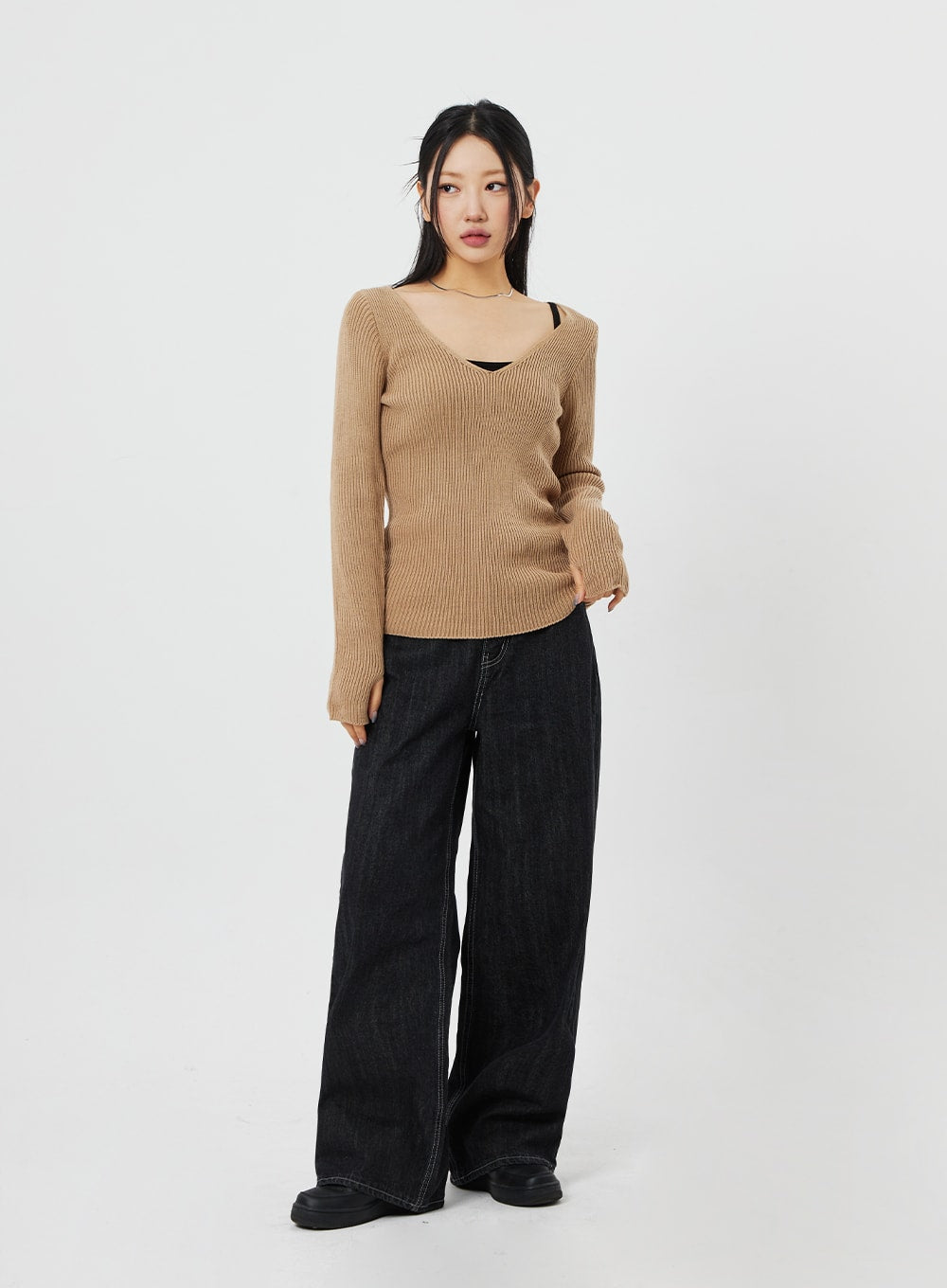 Straight Leg Jeans CF315 in black, full-body three-quarter front view on model, wide-fit straight cotton denim with contrast stitching, styled with camel ribbed knit.