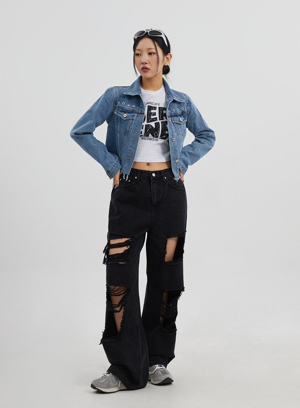 Ripped Wide Leg Jeans CJ319 in black, full-length front on model hands-on-hips pose, destroyed wide-leg denim with multi-level rips, paired with cropped blue denim jacket.