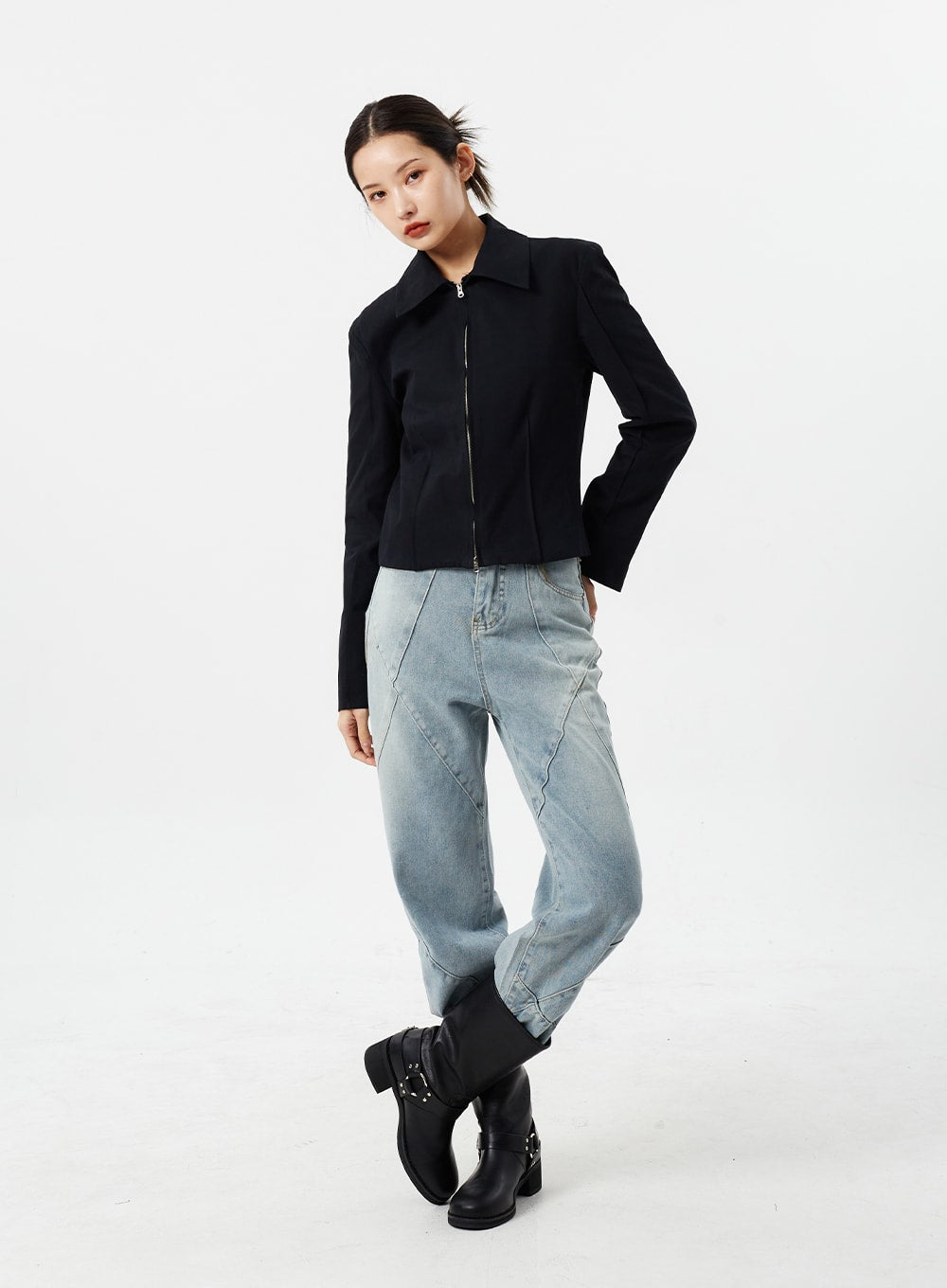 Light Wash Straight Leg Jeans CM307 in light blue, full-body three-quarter angle on model, relaxed straight-fit denim with diagonal seam detailing, paired with black cropped jacket and harness boots.