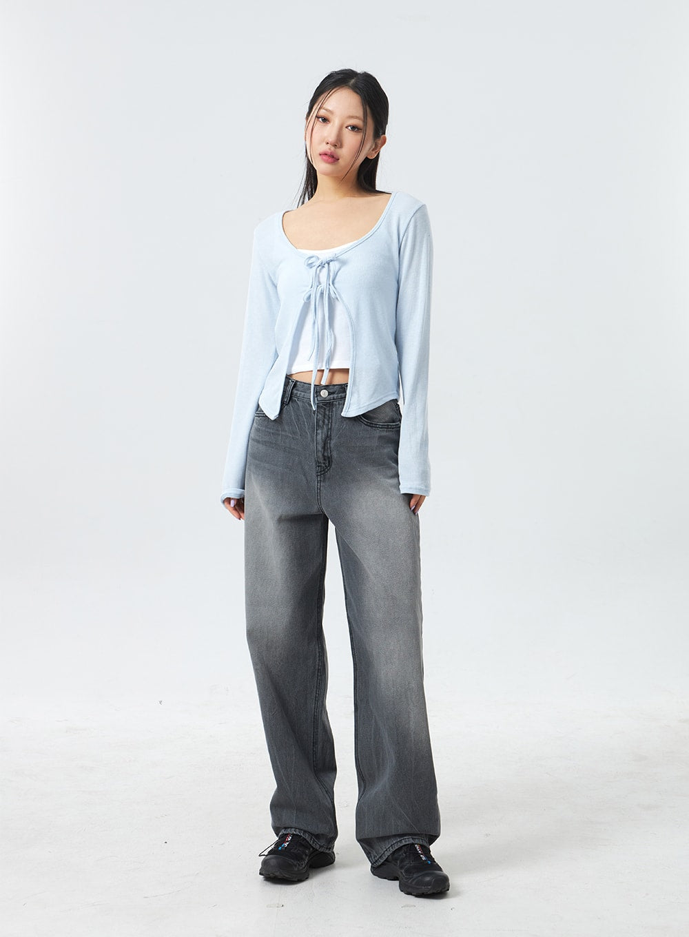 Low Rise Mid-Wash Jeans CM327 in grey, full-length front shot on model with relaxed stance, wide-leg washed cotton denim in muted grey, low waist, styled with sky blue tie-front top.