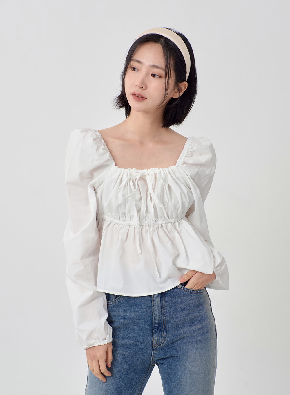 Light Washed Bootcut Jeans OD27 in light blue, upper-body and waist detail on model, high-rise waistband shown with cropped white ruffle blouse, slim-fit washed cotton denim, casual styling.