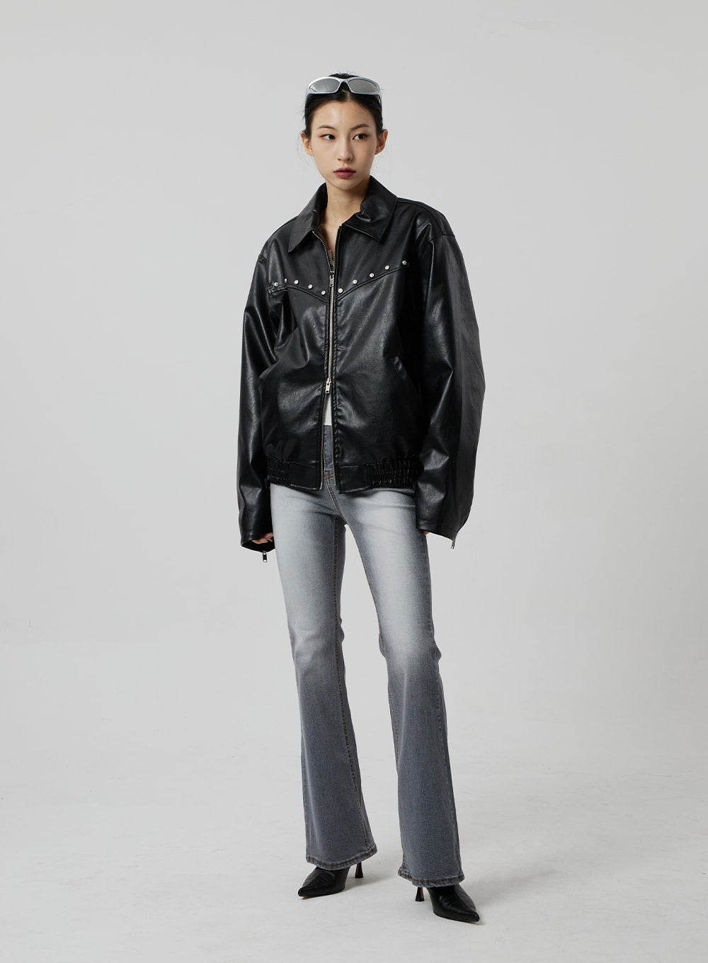 Slim Fit Bootcut Jeans CF307 in grey, full-length front view on model, high-rise bootcut with washed grey denim, styled with black studded oversized jacket and pointed kitten heels.