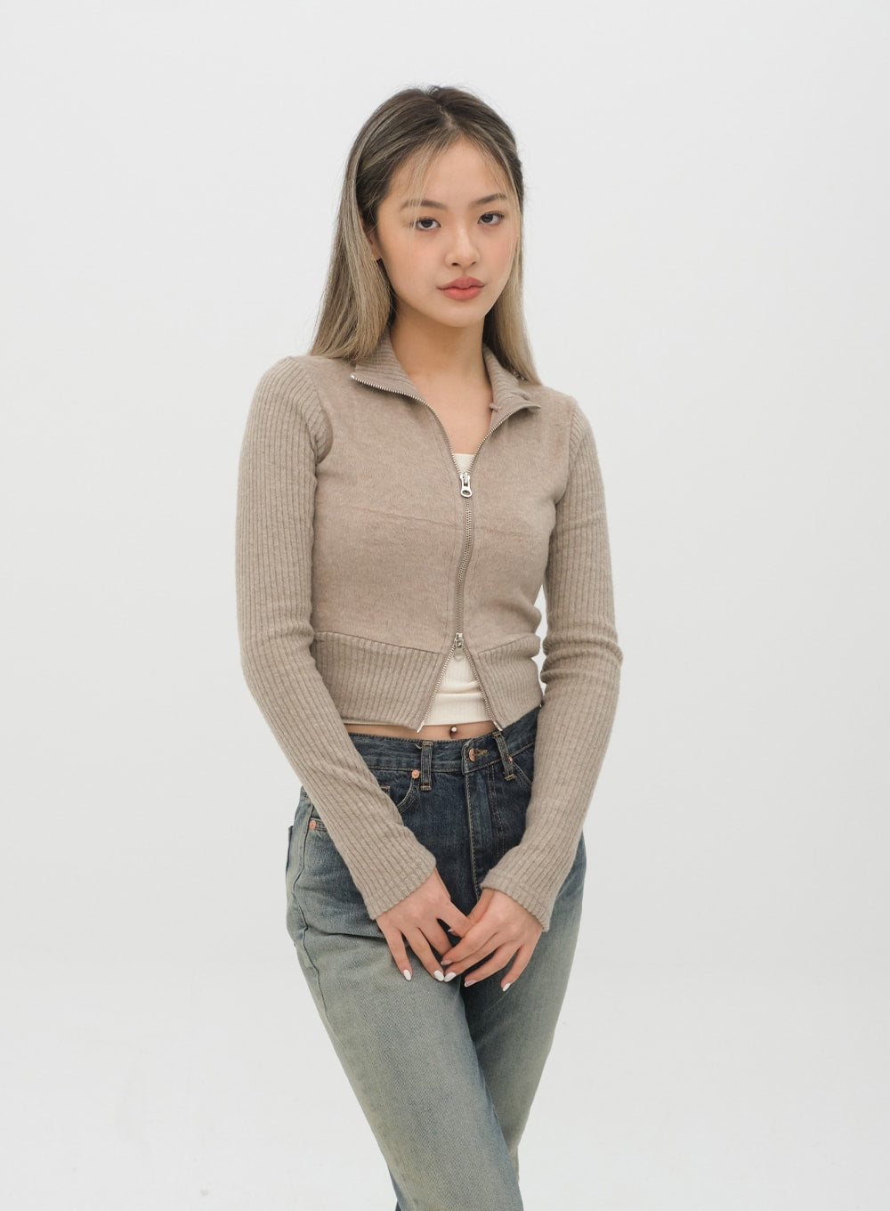 Boot Cut Jeans J20 in Dark Denim, upper-body angle shot on model, high-rise waistband and front pocket detail visible, gradation denim paired with beige zip knit.