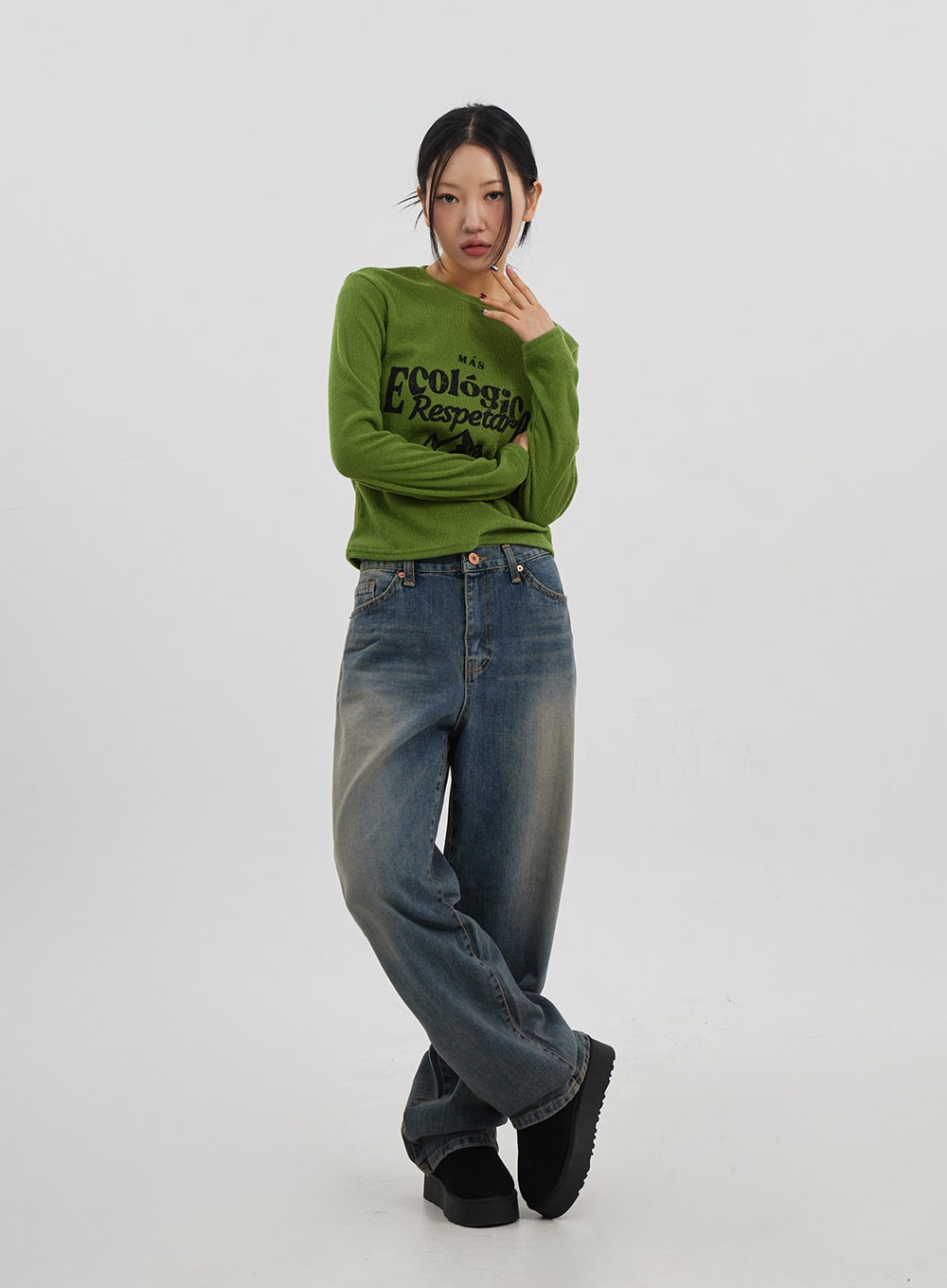 Mid-Rise Baggy Jeans Unisex CJ330 in vintage blue, full-body front view on model in relaxed crossed-leg pose, wide-fit faded cotton denim with baggy silhouette and slight hem stack.
