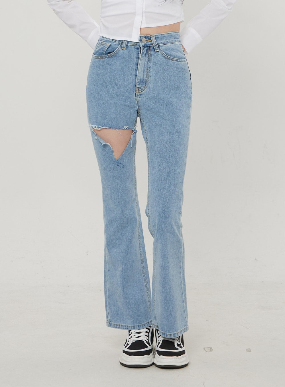 Ripped Bootcut Jeans BF306 in light blue, front waist-to-hem crop shot on model, large frayed thigh rip detail and high-rise waistband prominent, slim bootcut silhouette.
