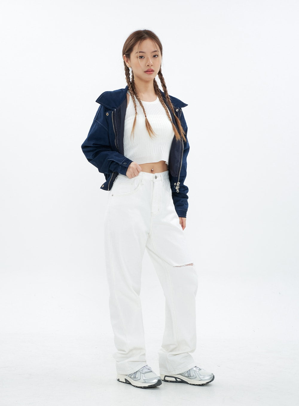 Torn Wide Leg Jeans CM18 in white, full-body front view on model hands in pocket, wide-fit long cotton jeans with knee cut-out, paired with white ribbed crop top and navy jacket.