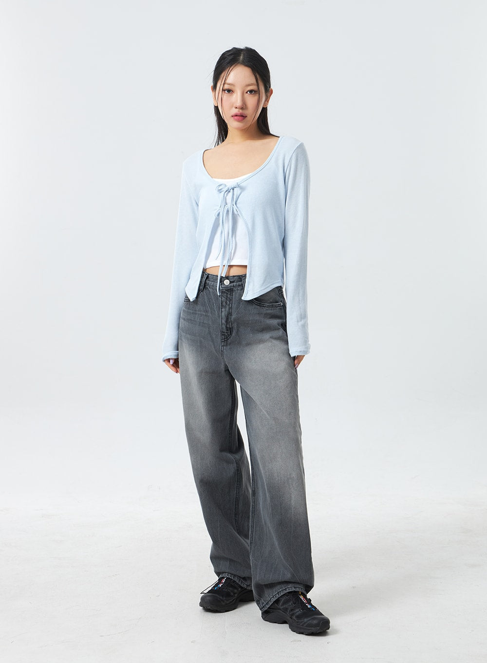 Low Rise Mid-Wash Jeans CM327 in grey, full-length front shot on model looking to side, low-rise wide-leg denim with graduated grey mid-wash, casual cotton fabric, paired with light blue cardigan.