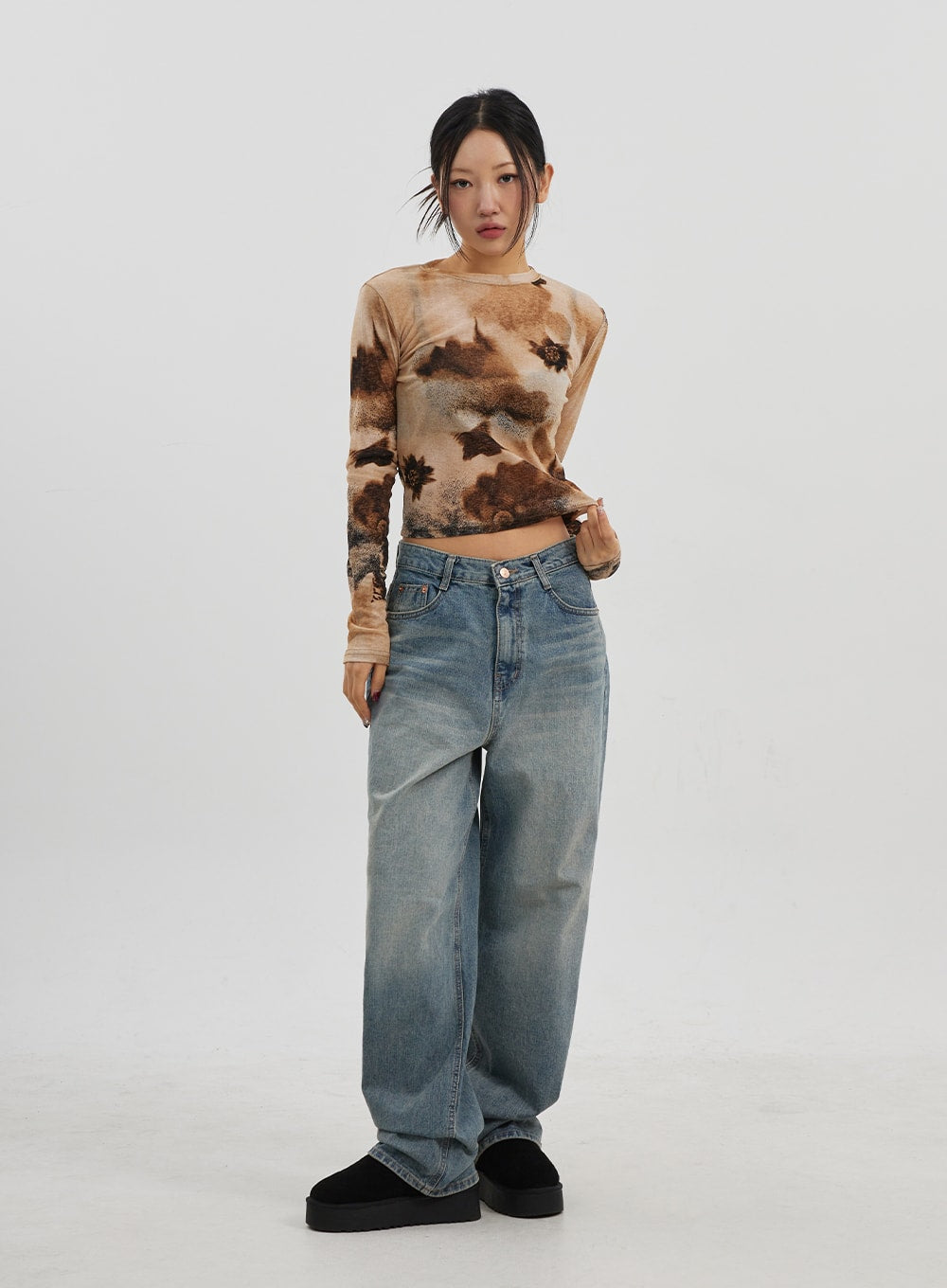 Low Rise Baggy Jeans CJ330 in Blue, full-body front shot on model standing straight, low-waist baggy wide-leg cotton denim with faded vintage wash, paired with tie-dye top.