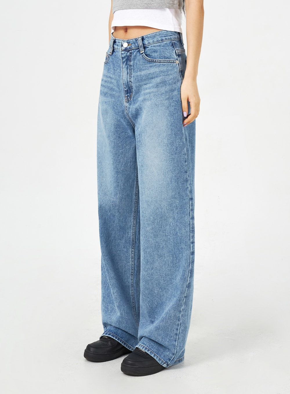 Mid-Wash Bootcut Jeans CM323 in mid blue, side-angle waist-to-floor close-up on model, high-rise wide-fit washed cotton denim with clean front seam and flared bootcut leg.