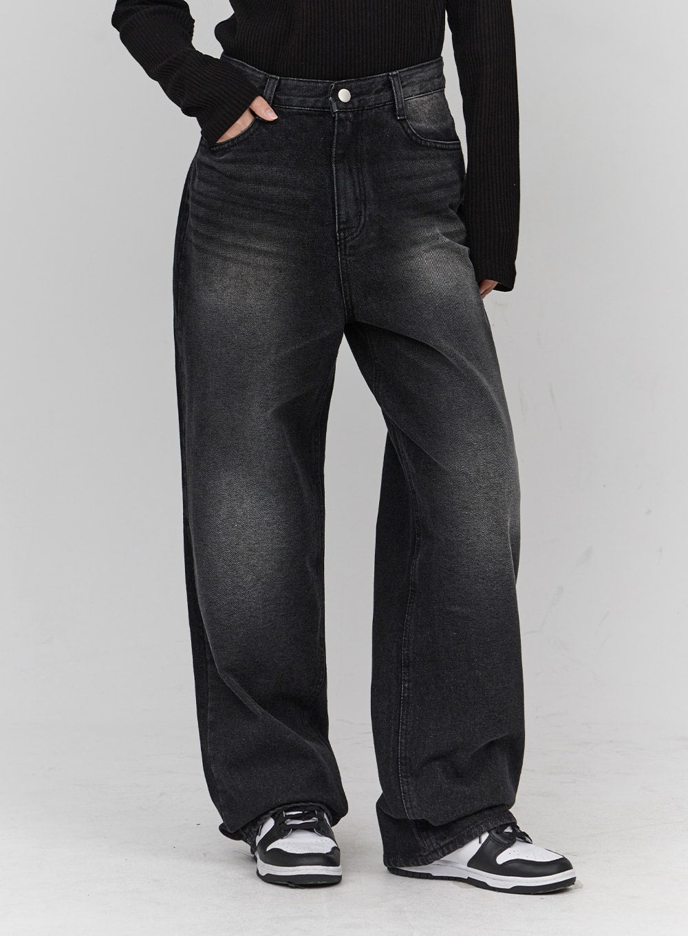 Light Washing Wide Leg Black Jeans CN23 in washed black, front waist-to-hem close-up on model, wide leg cotton denim with gradient faded wash, silver button detail, hand in pocket.