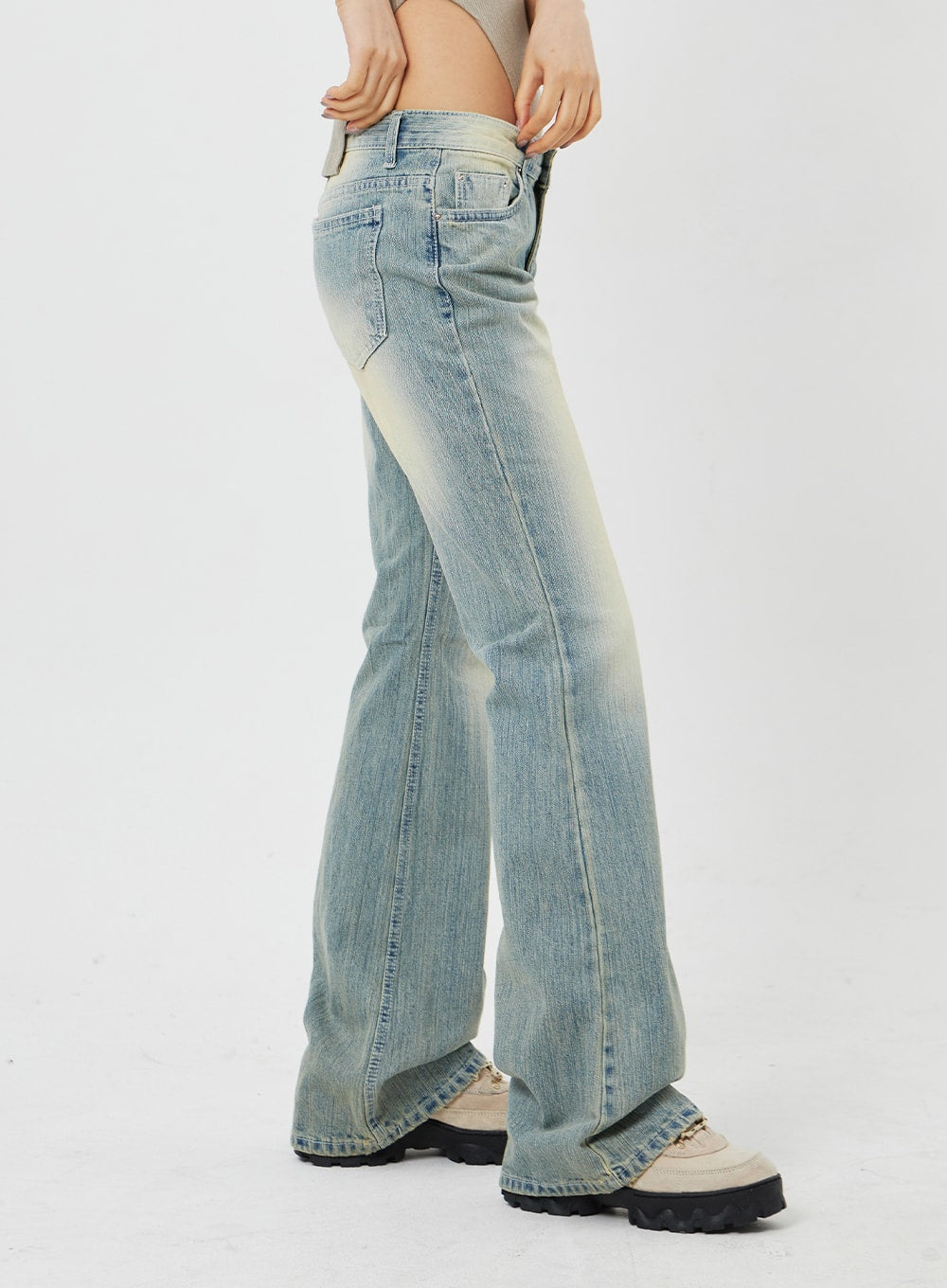 Low Rise Bootcut Jeans CF315 in light blue, side full-length close-up on model, low-rise profile highlighting slim fit through thigh and gentle bootcut flare, vintage wash.