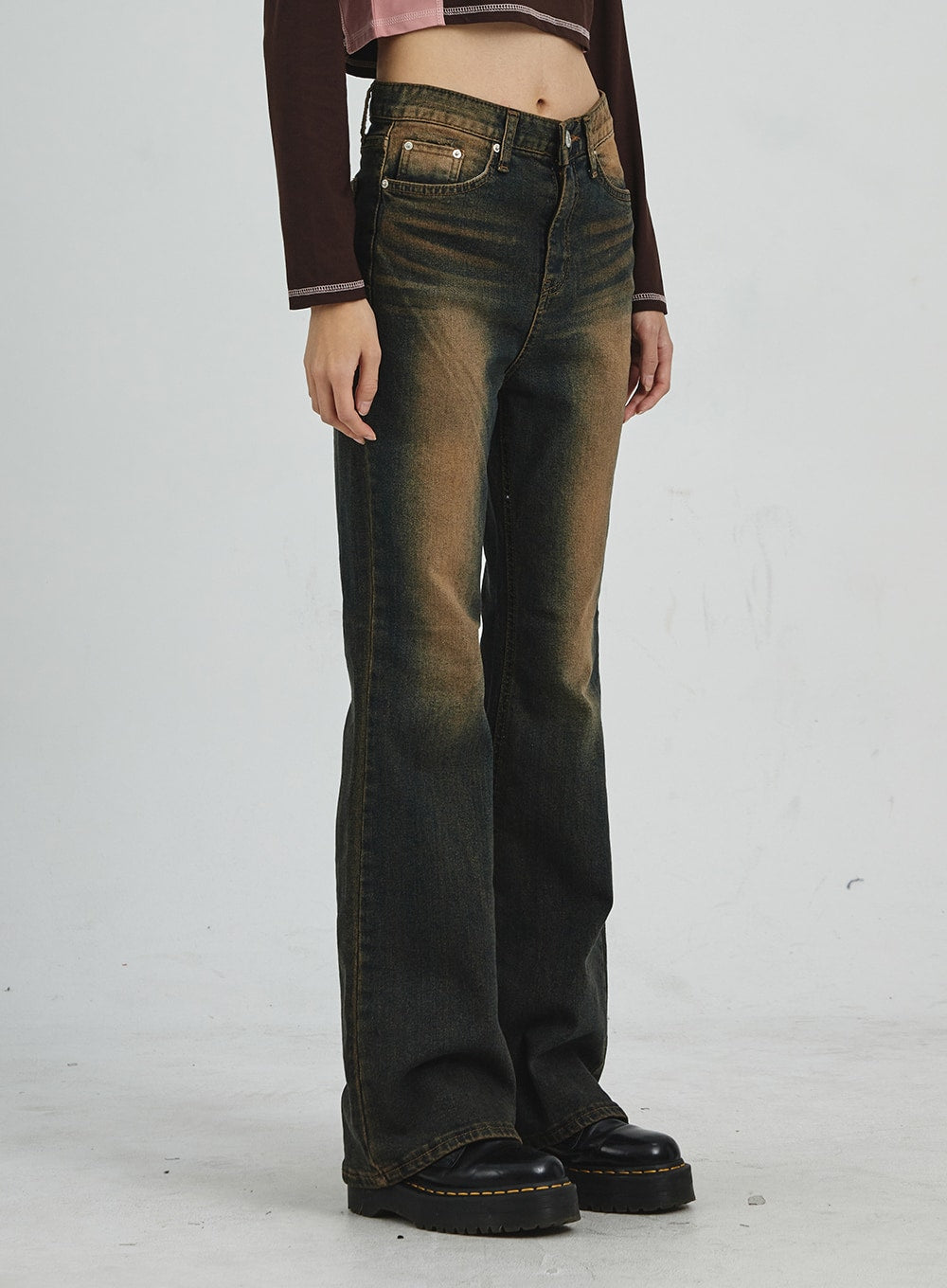 Vintage Washing Bootcut Jeans CD02 in dark washed denim, side close-up waist-to-hem on model, front pocket hardware detail visible, warm amber wash graduating to dark indigo bootcut hem.