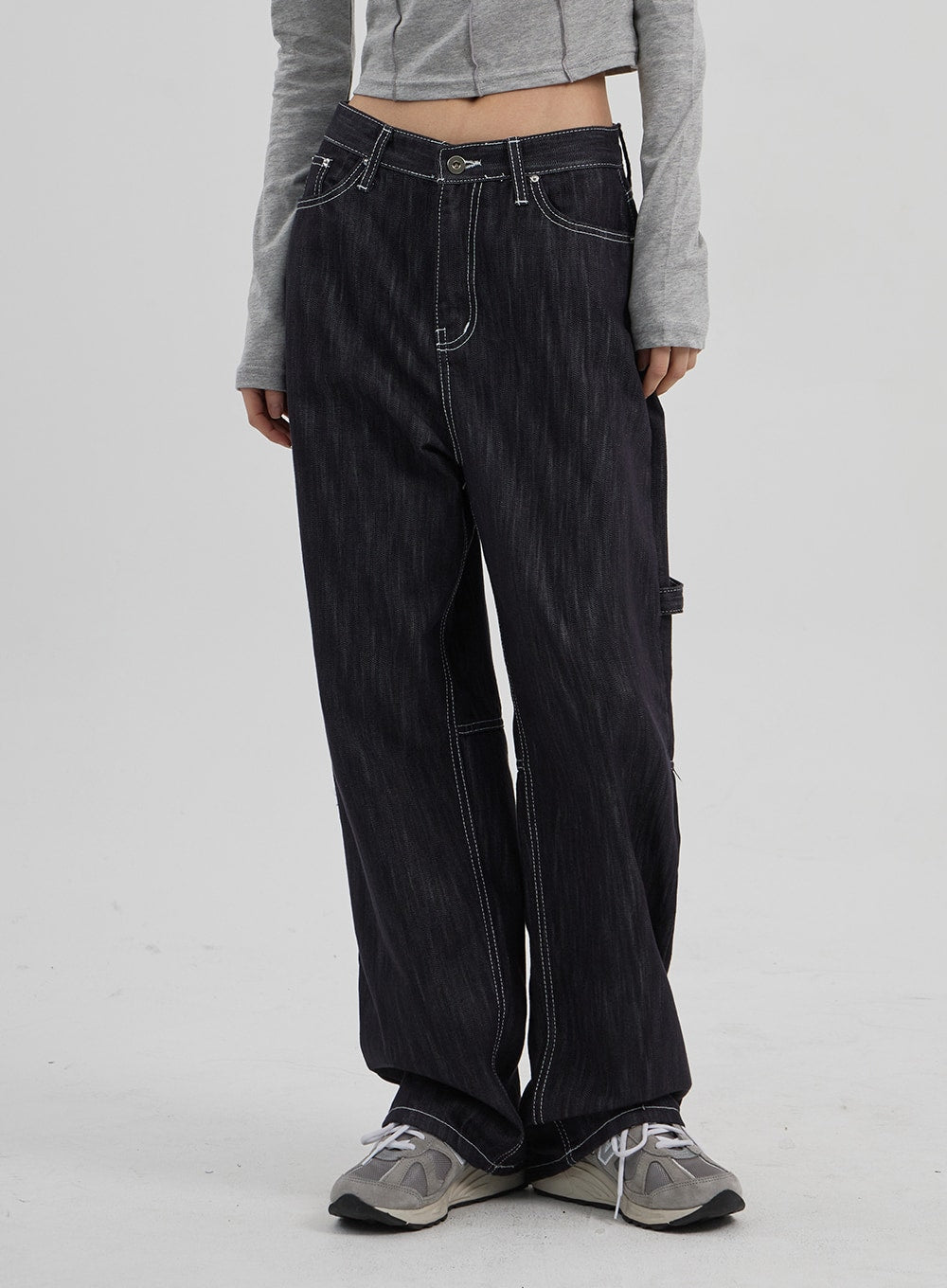 Mid-Rise Baggy Jeans CF307 in dark indigo, front waist-to-hem close-up on model, mid-rise five-pocket silhouette with white contrast stitching and wide straight leg, paired with grey crop top.