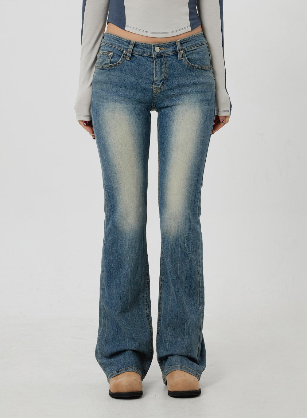 Low Rise Bootcut Jeans CF302 in blue, full-length front product shot on model, low-rise five-pocket design, cotton-blend denim with light centre fade, bootcut flare at ankle.