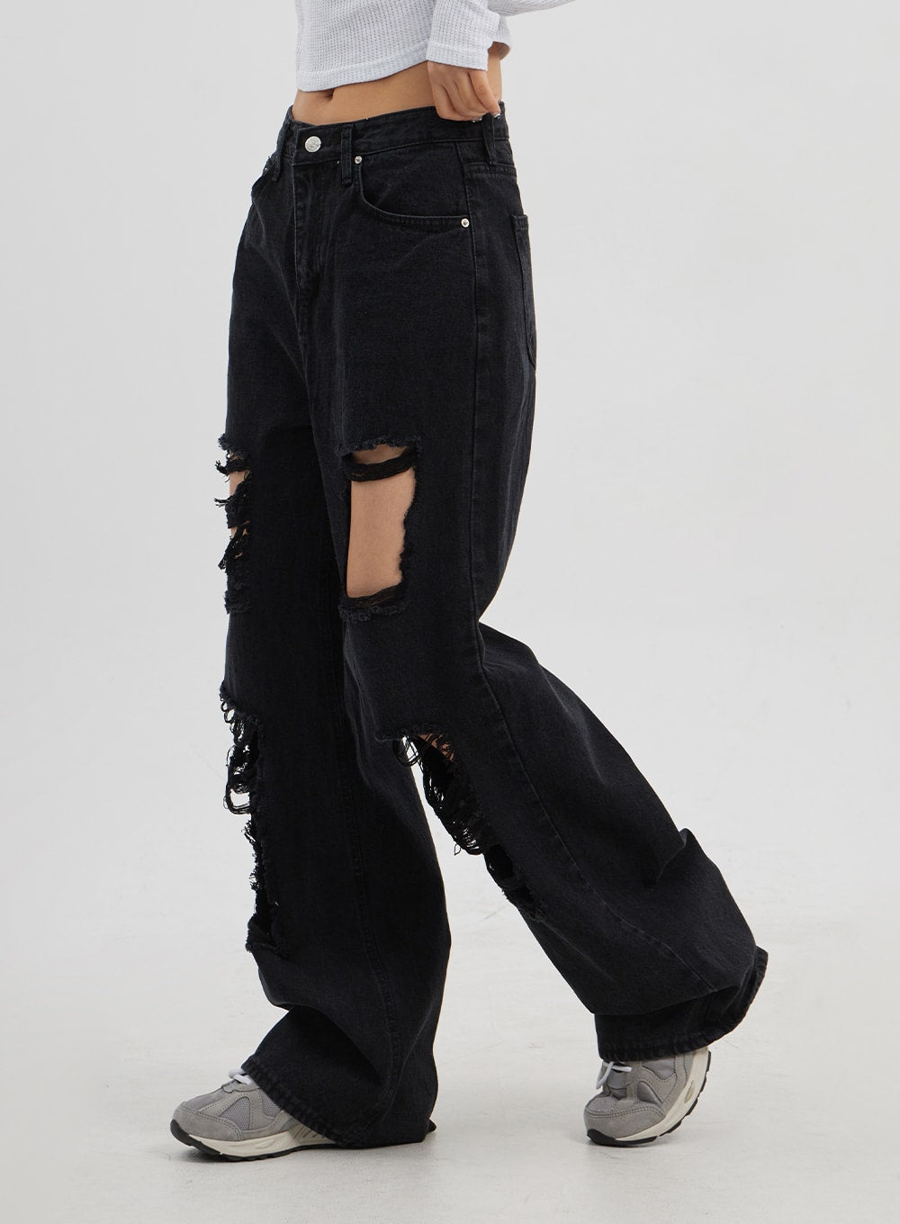 Ripped Wide Leg Jeans CJ319 in black, side view on model, thigh-to-calf rip openings with heavy fraying visible from side angle, extra-wide leg drape in washed cotton denim.