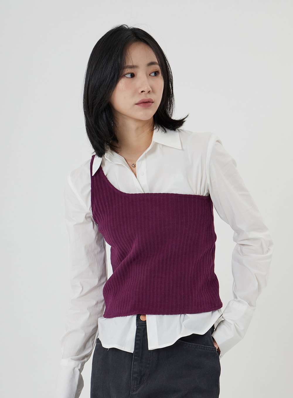 Maxi Denim Pants ON23 in charcoal grey, upper-body and waistband close-up on model, wide-fit denim waist detail visible, styled with white shirt and purple ribbed knit vest.