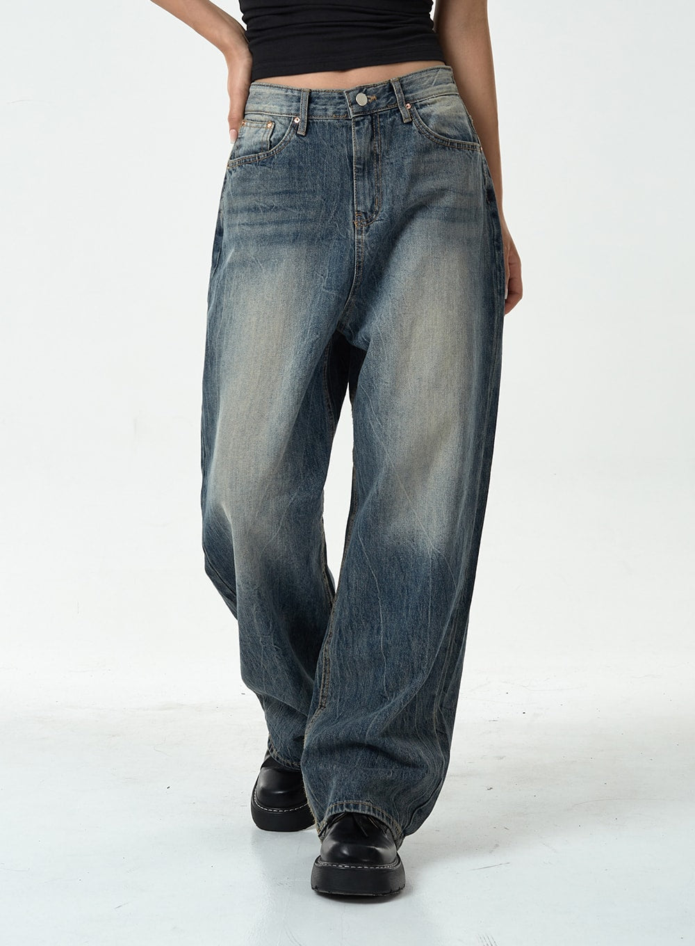 Washed Denim Pants CG10 in dark blue, front mid-body close-up on model, wide-leg straight denim highlighting washed fading on thighs and five-pocket construction, mid-rise fit.