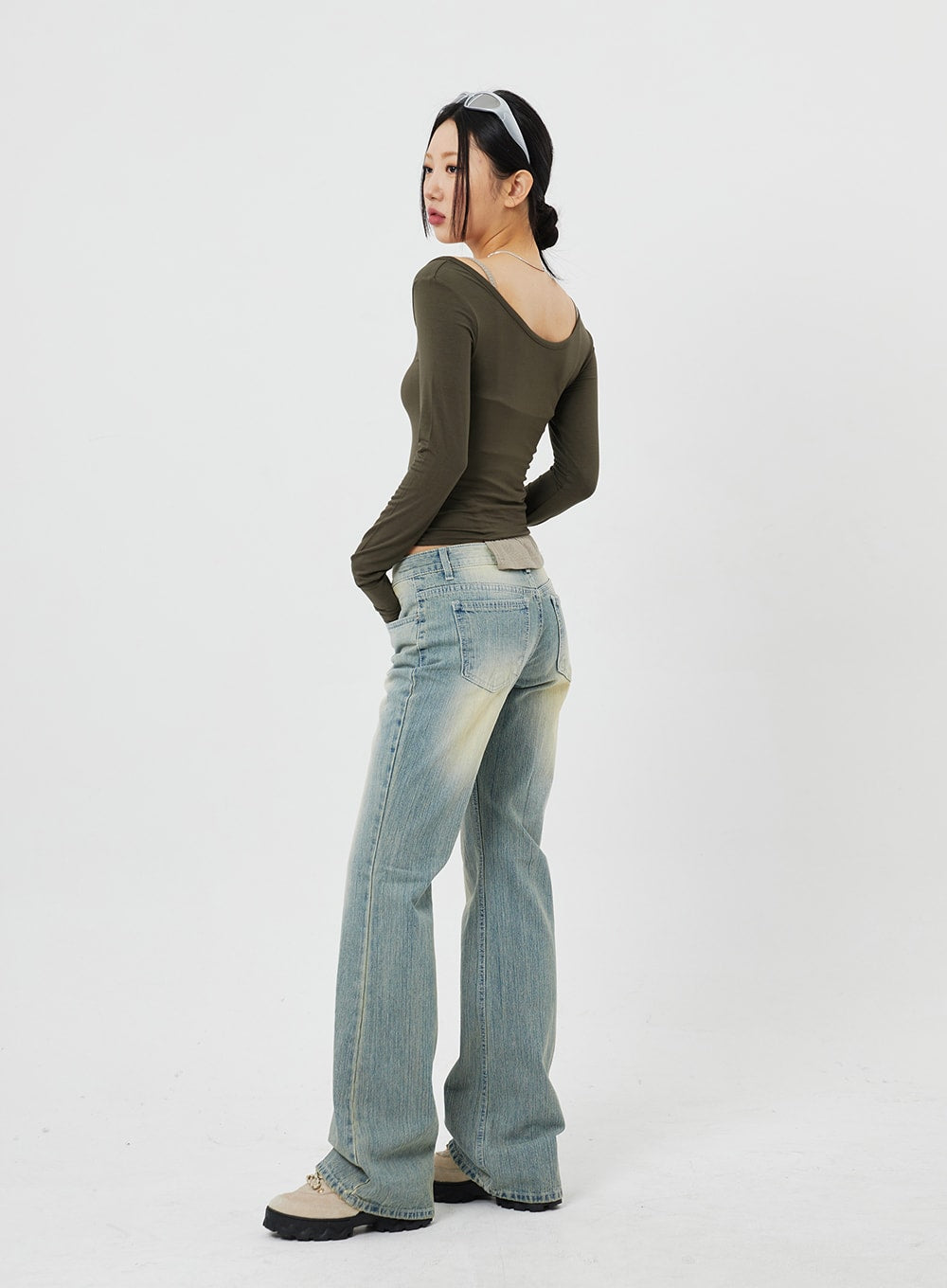 Low Rise Bootcut Jeans CF315 in light blue, back three-quarter full-length shot on model, rear pocket detail visible, low waistband with faded wash, bootcut leg silhouette.