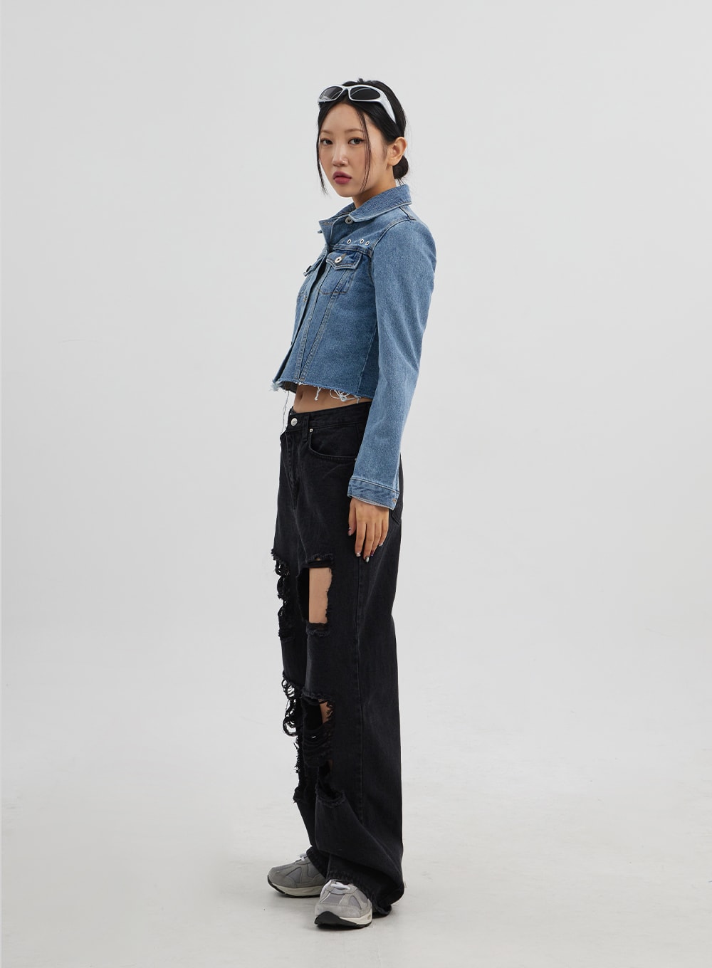 Ripped Wide Leg Jeans CJ319 in black, side profile full-length on model, thigh rip detail prominent, wide-leg floor-length silhouette, styled with blue cropped denim jacket.