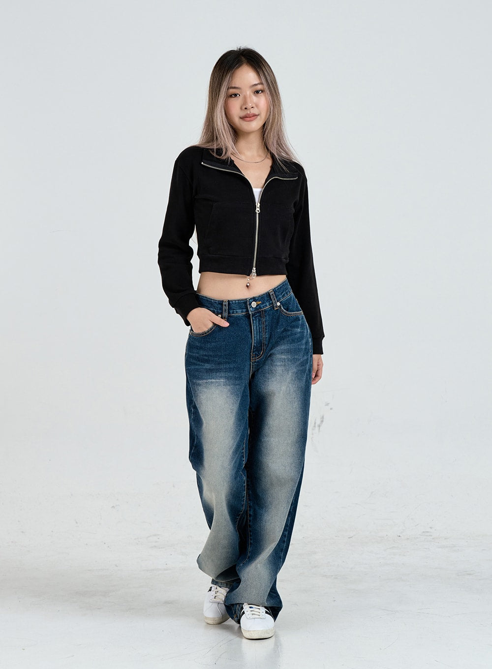 Wide Leg Faded Color Denim Pants CO11 in blue gradation, full-body front walking shot on model, relaxed casual stride, gradation denim draping over sneakers, black crop zip jacket styling.