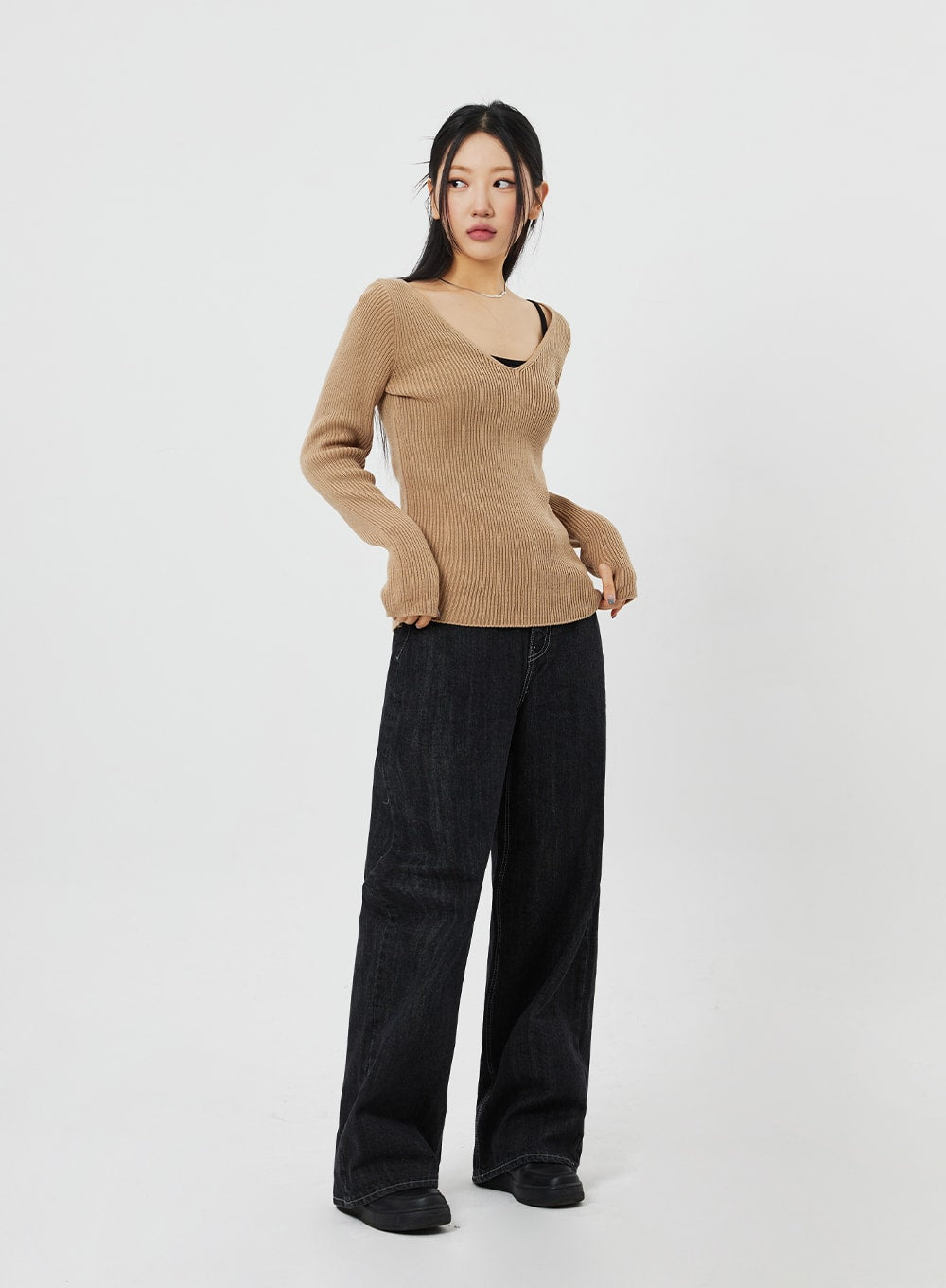 Straight Leg Jeans CF315 in black, full-body side-angled view on model, wide-fit straight cotton denim with contrast stitching, styled with camel ribbed knit and black loafers.