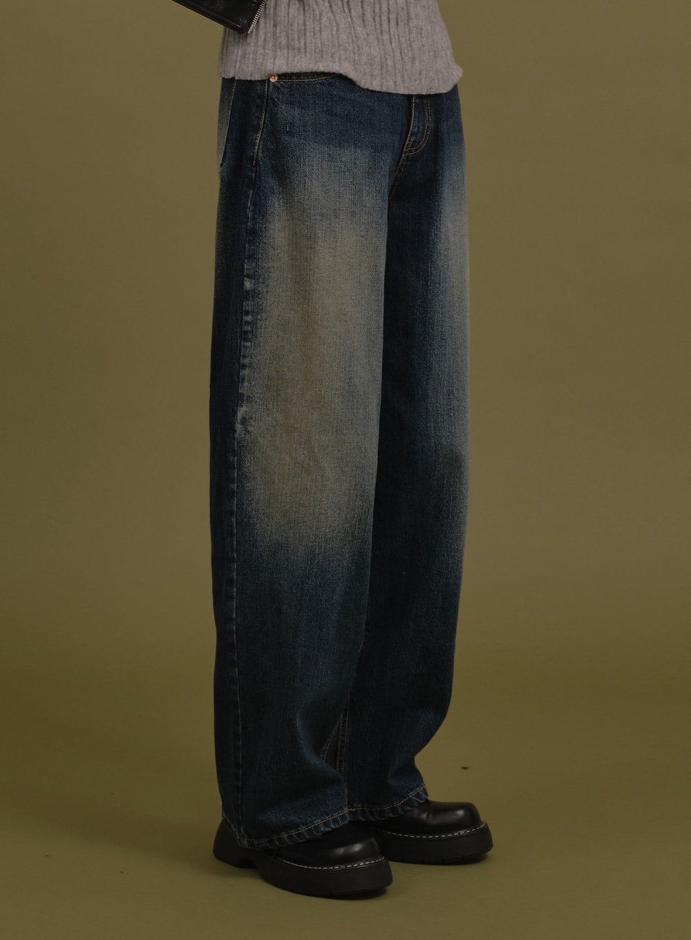 Washed Wide Denim Pants in blue, side view close-up on model, straight wide leg silhouette with visible washed gradation and cotton texture, with black chunky loafers.