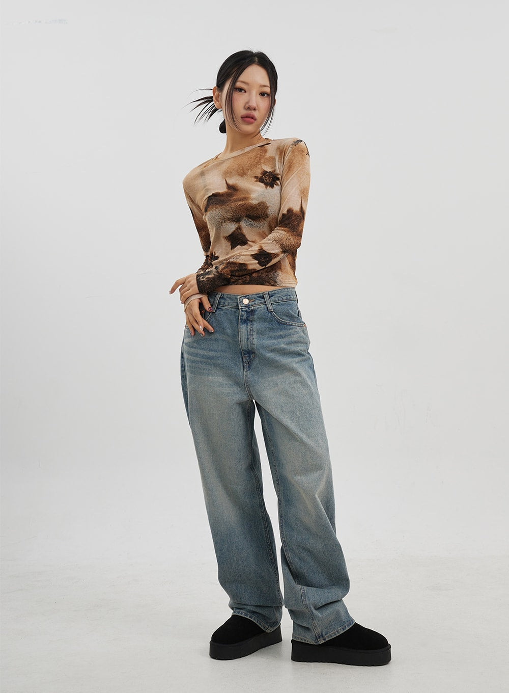 Low Rise Baggy Jeans CJ330 in Blue, full-body slight-angle front shot on model, low-rise wide-fit washed denim with relaxed drape, paired with tie-dye crop top and platform shoes.