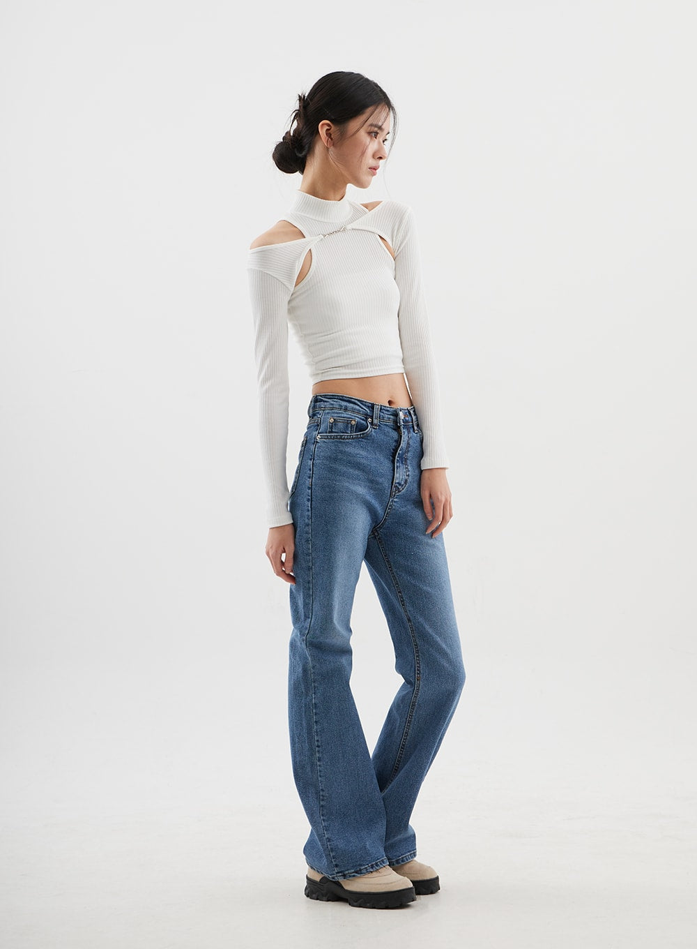 Slim Fit Bootcut Jeans CJ311 in medium blue, three-quarter back-angle full-length on model, bootcut hem sweep visible, mid-rise waistband, paired with white ribbed crop top.