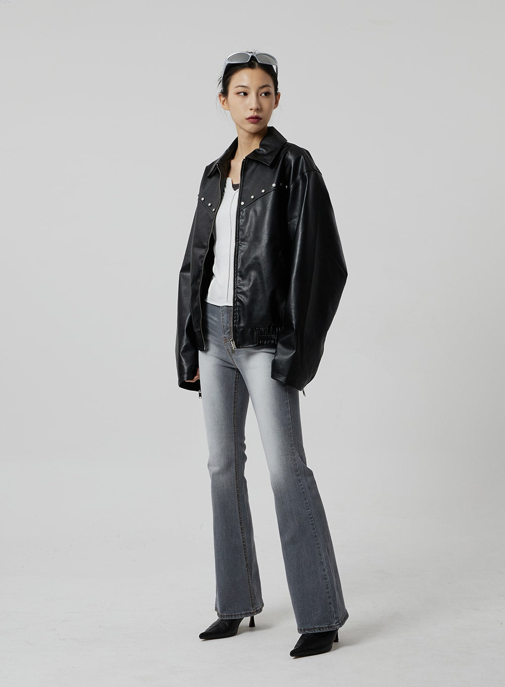 Slim Fit Bootcut Jeans CF307 in grey, full-length front view on model looking aside, slim bootcut silhouette, washed denim, paired with open black leather jacket and white tee.
