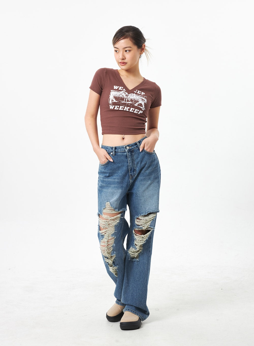 Wide Ripped Jeans CA304 in medium blue, full-body front on model with hands in pockets looking down, wide-leg washed denim with heavy distressed knee rips in street style.