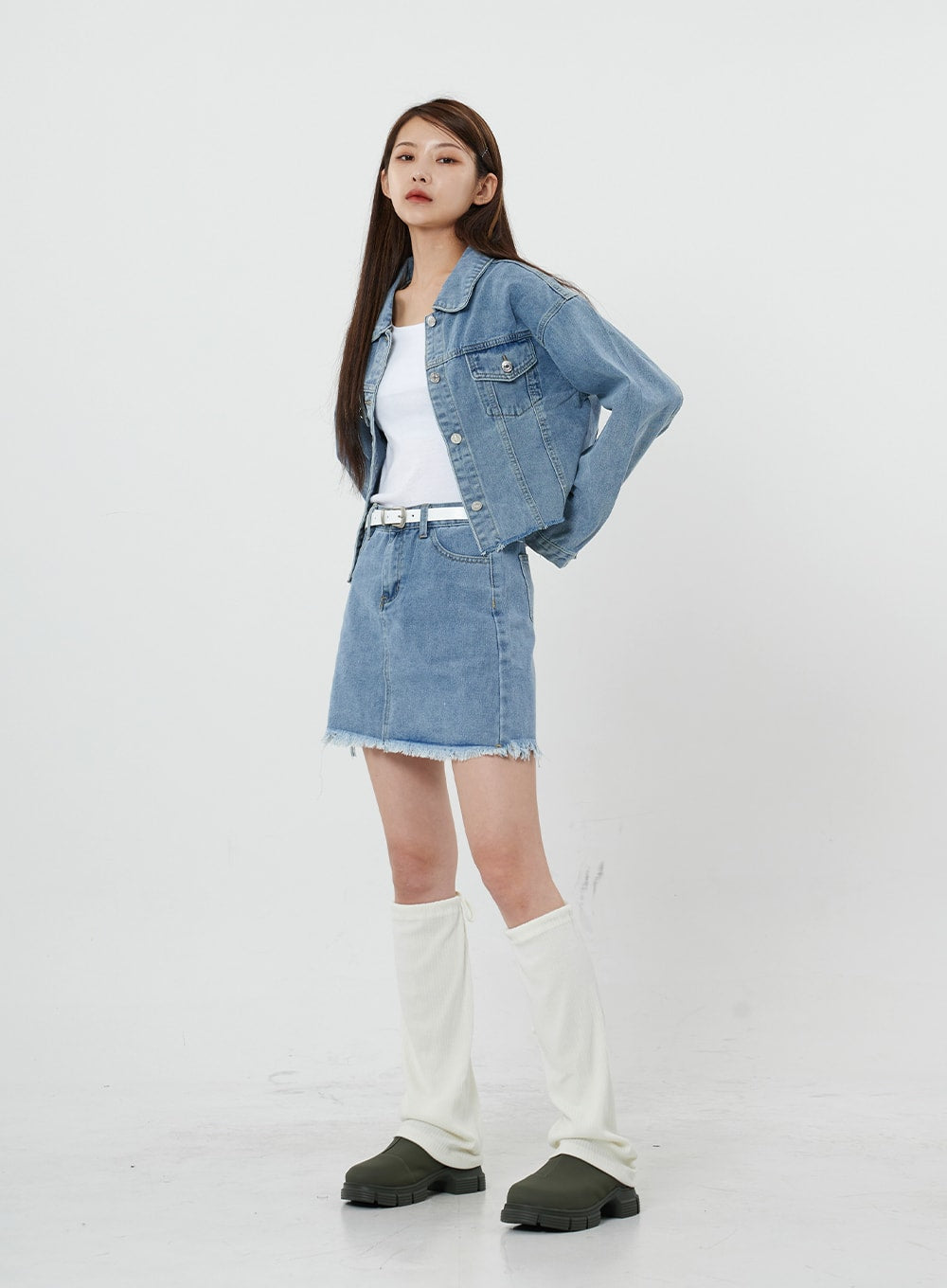 Sienna Crop Jeans Jacket CS21 in light blue, three-quarter front view on model, open-front crop denim jacket with collar detail, styled with denim mini skirt and white knee boots.