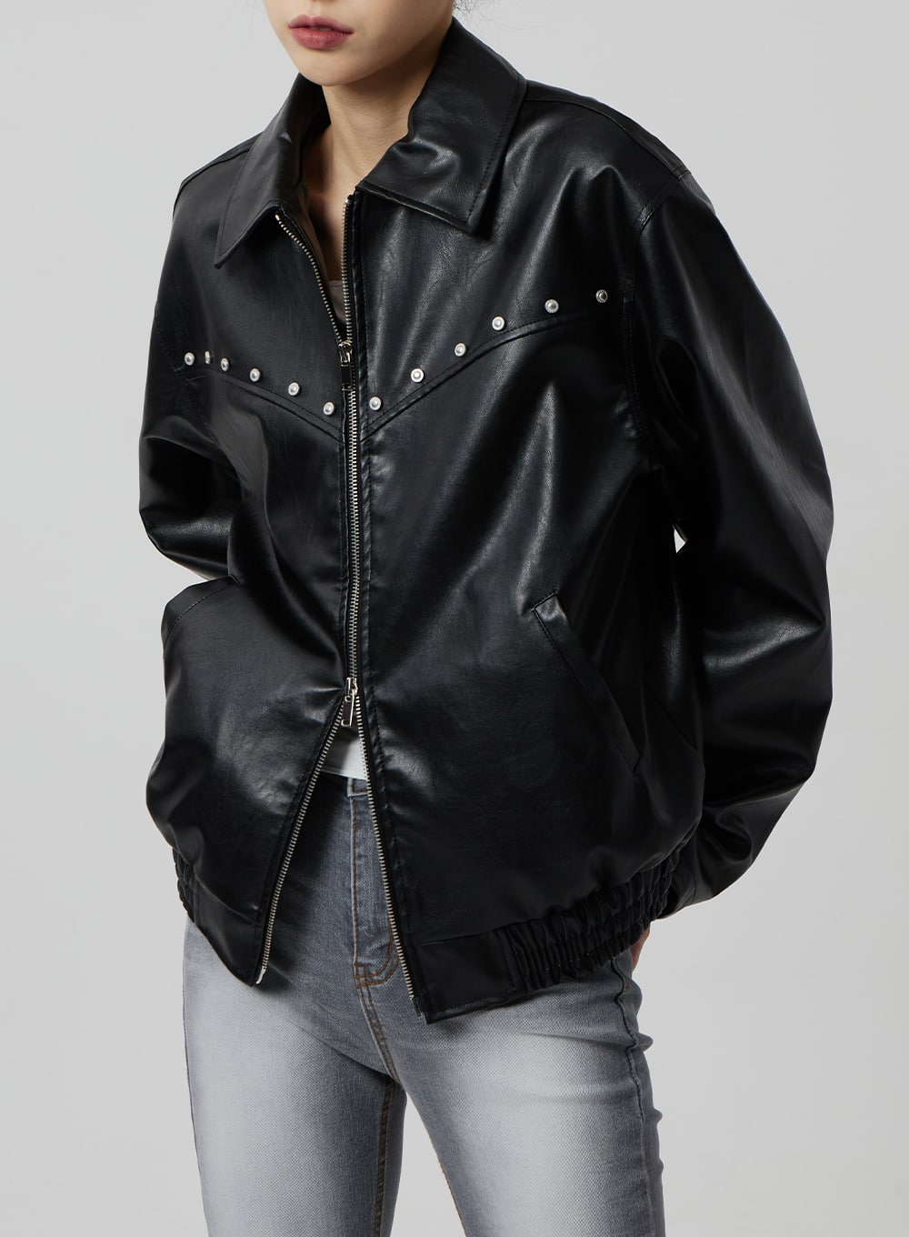 Slim Fit Bootcut Jeans CF307 in grey, upper-thigh detail visible behind model wearing black faux-leather jacket, slim high-rise waistband and washed denim texture partially shown.