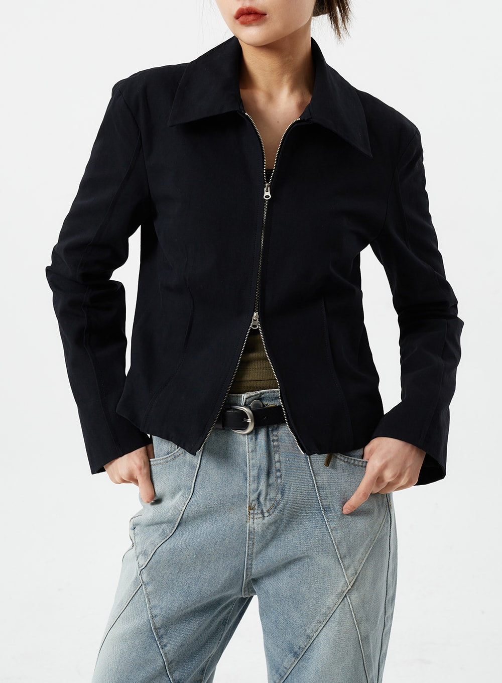 Light Wash Straight Leg Jeans CM307 in light blue, upper waist close-up on model, geometric seam detail at hip visible, high-rise waist with belt, paired with black zip-front jacket.