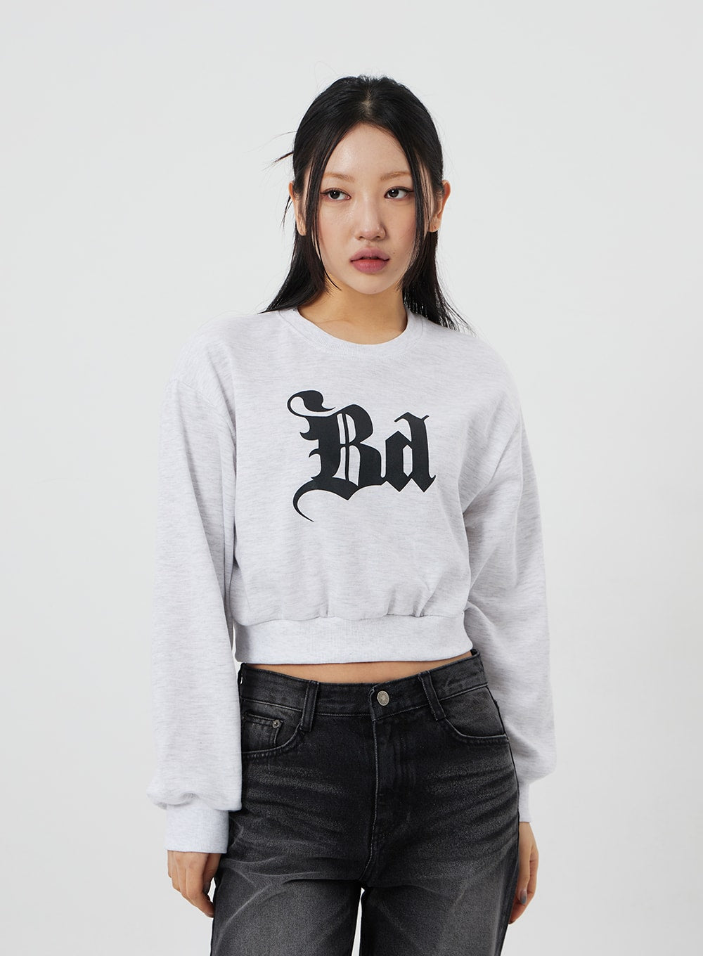Mid-Rise Bootcut Jeans CF327 in black, upper-body front close-up on model, waistband and front pockets visible below grey crop sweatshirt, dark washed denim texture shown.