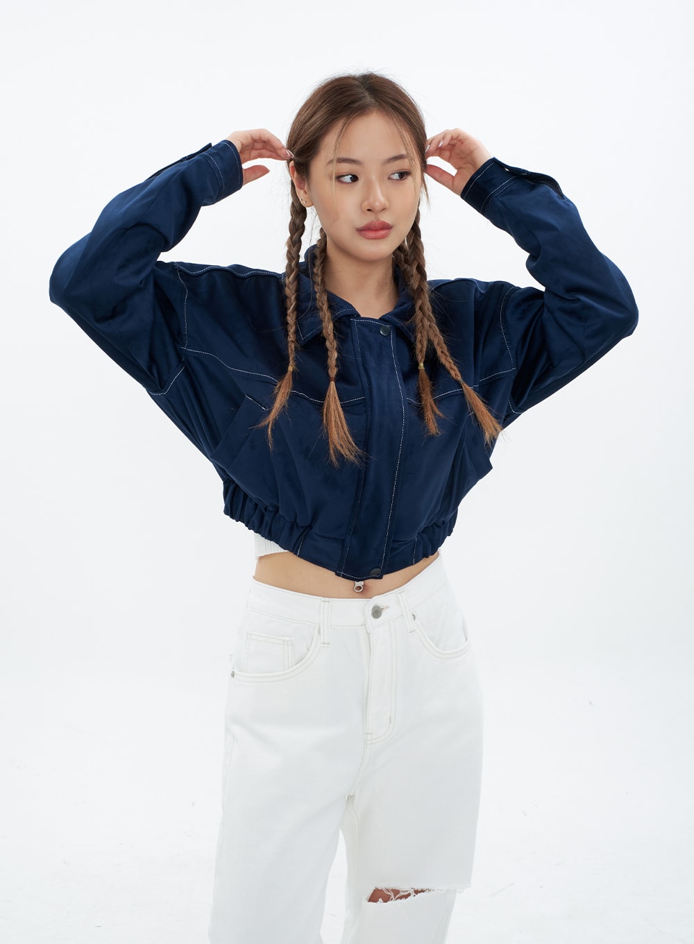 Torn Wide Leg Jeans CM18 in white, upper-body front shot on model with hands raised, waistband and front pocket with contrast stitching visible, knee cut-out shown, layered with navy jacket.