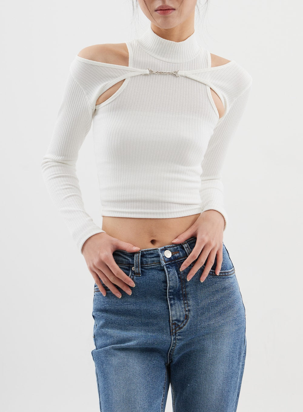Slim Fit Bootcut Jeans CJ311 in medium blue, upper front close-up on model, mid-rise waistband with button and belt loops detail, hands resting on waistband, washed blue denim.