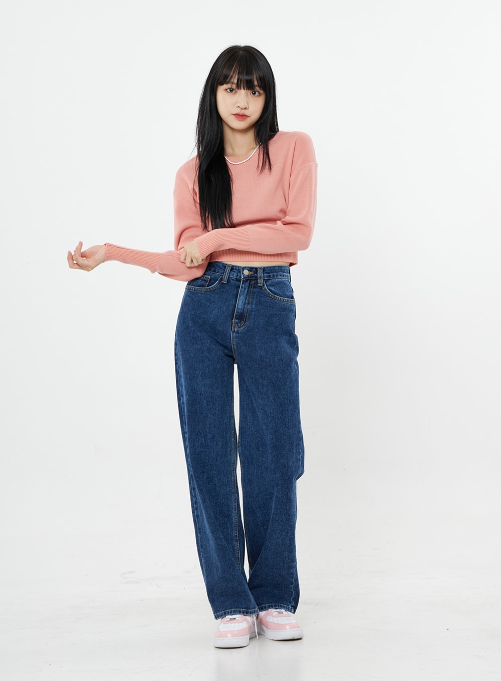 Basic Long Denim Pants BS28 in mid-blue, front full-body on model with arms extended, high-rise straight-fit wide-leg cotton denim, paired with pink ribbed crop sweater.