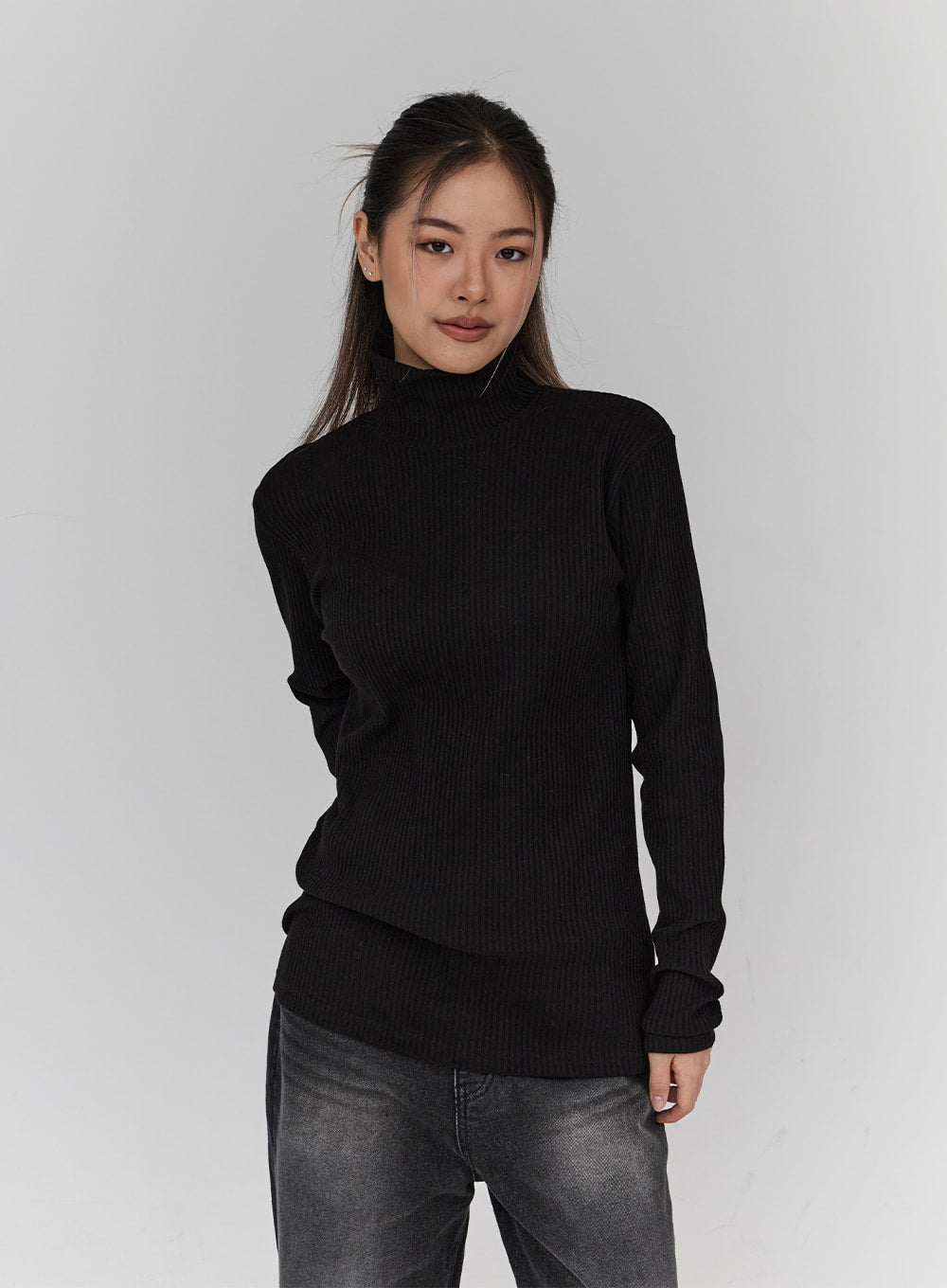 Light Washing Wide Leg Black Jeans CN23 in washed black, upper-body crop view on model, jeans partially visible at hip, styled with fitted black ribbed turtleneck, front-facing pose.
