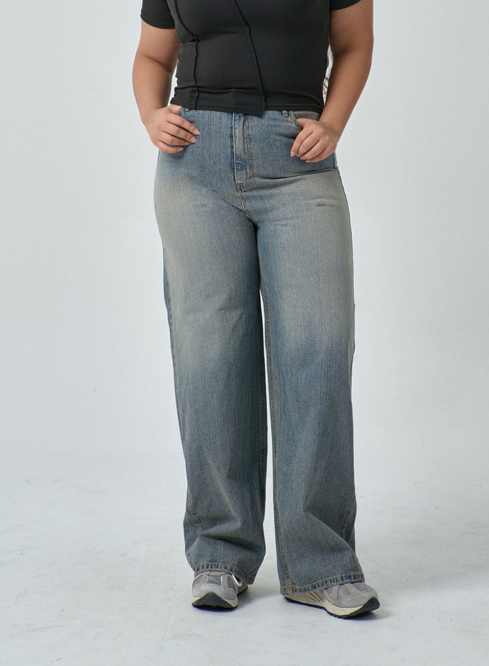 Plus Light Wash Wide Leg Jeans IF317 in light blue wash, front waist-to-hem crop on plus-size model, wide leg denim with vintage-wash fade and five-pocket detail, paired with black fitted top.