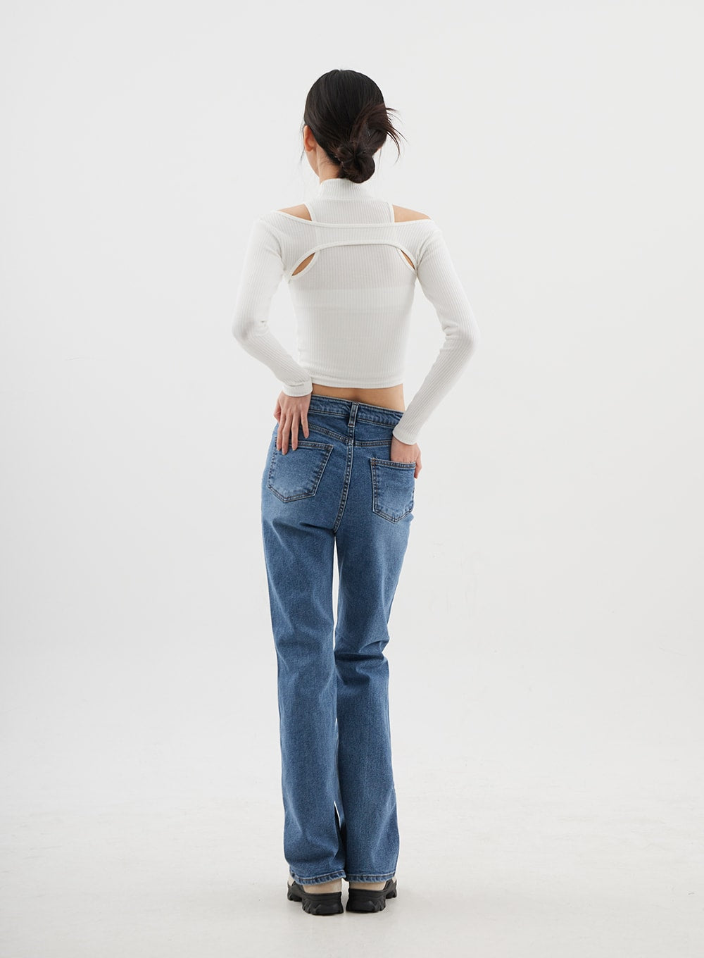 Slim Fit Bootcut Jeans CJ311 in medium blue, full-length back view on model, back yoke and dual patch pockets visible, bootcut flare at hem, styled with white ribbed turtleneck crop.