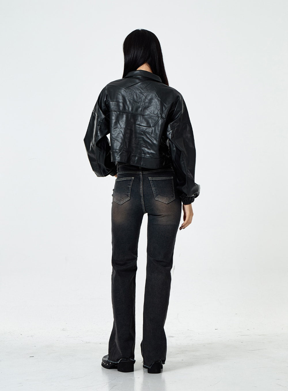 Basic Washed Bootcut Jeans CS07 in black washed denim, full-length back view on model, back pockets with contrast stitching, bootcut flare at hem, faded wash, black crop leather jacket above.