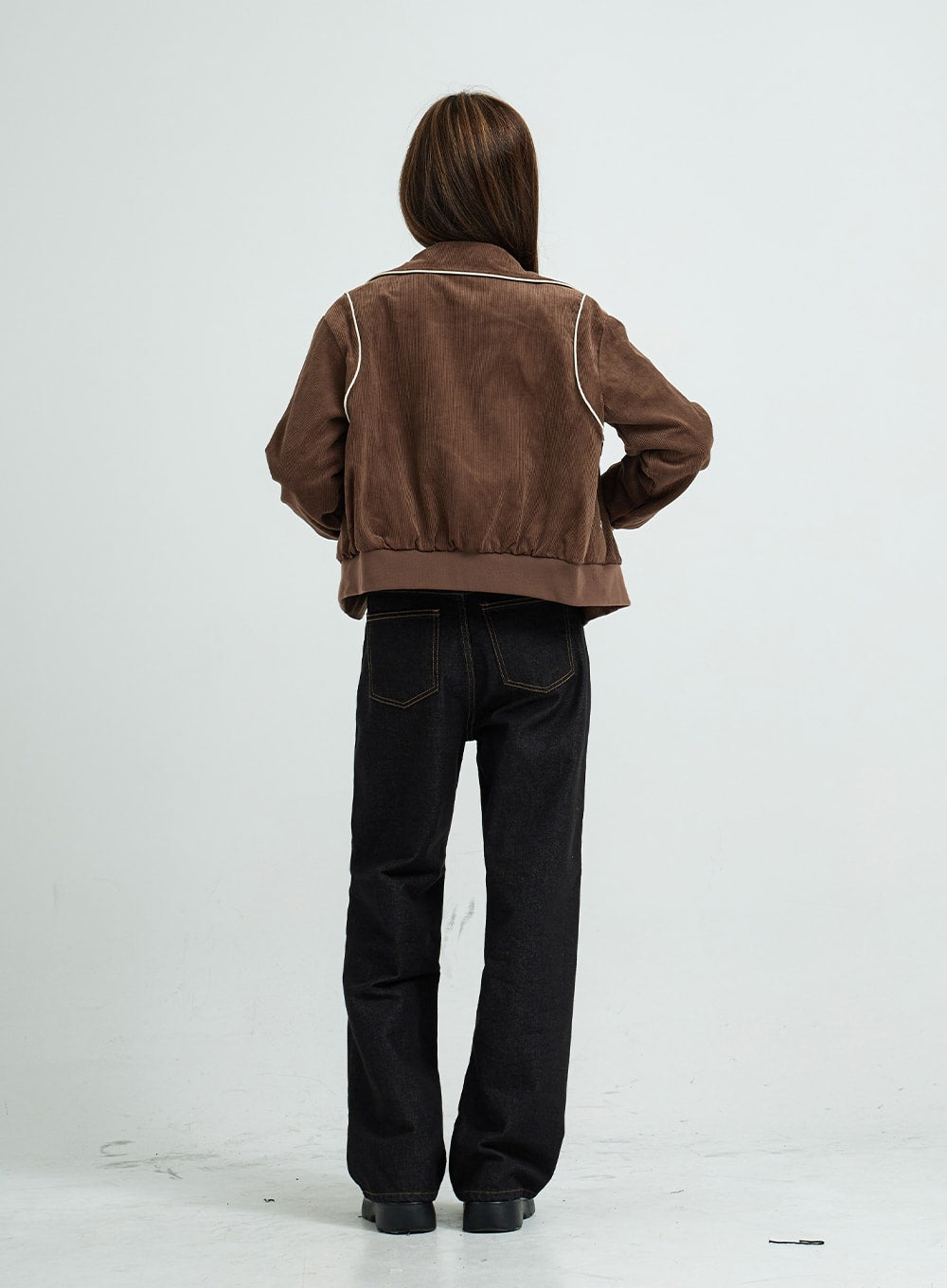 Pepe Wide Pants CS15 in black, full-length back view on model, wide-fit cotton denim showing back pockets with contrast stitching and straight wide leg, styled with brown cropped jacket.