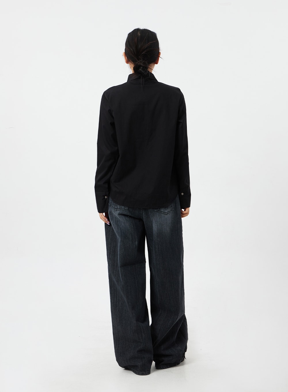 Mid-Rise Baggy Jeans CM324 in washed black denim, full-body back view on model, wide-leg silhouette and back pockets visible, paired with black long-sleeve shirt.